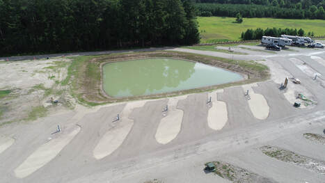 Picture of our pond back-in sites, ready for you to fish from the back of your camper.